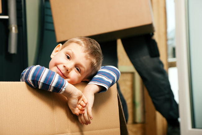 photo of young boy, the child of a separating couple in Edmonton, moved into a new home with one of his parents, enjoying his new bedroom